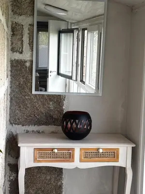 a mirror sitting on top of a vanity in a room at Carballo Alenza in Sistín