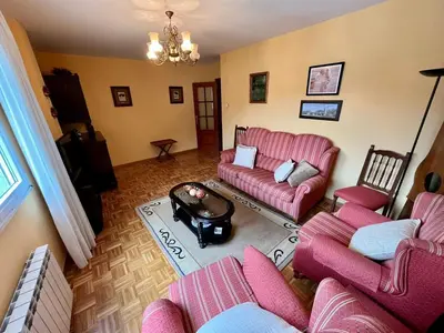 a living room with pink couches and a table at Apartamento en A Pontenova in A Pontenova