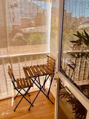 a bench sitting in front of a window at Cosmevixia in Ourense