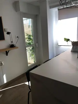 a white room with a table and a window at Cosmevixia in Ourense