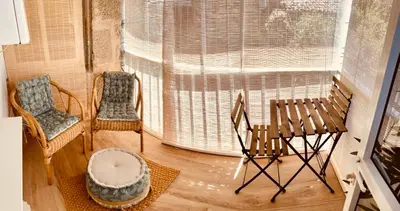 a living room with two chairs and a window at Cosmevixia in Ourense