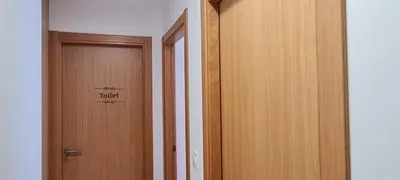 a hallway with a door with a sign that reads toilet at Agradable apartamento a 2 minutos de la playa in Ares