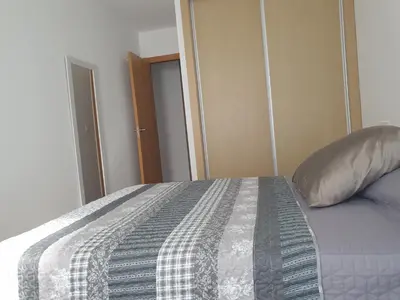 a bedroom with a bed with a pillow on it at Agradable apartamento a 2 minutos de la playa in Ares