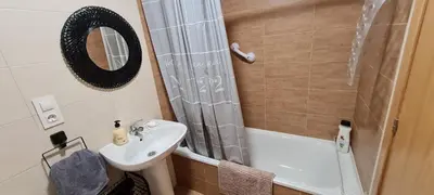 a small bathroom with a sink and a shower at Agradable apartamento a 2 minutos de la playa in Ares