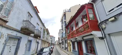 a street with buildings and a car parked on the street at Agradable apartamento a 2 minutos de la playa in Ares