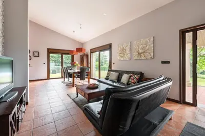 a living room with a couch and a table at Casa A Pedriña in Amés