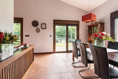 a dining room with a table and chairs at Casa A Pedriña in Amés