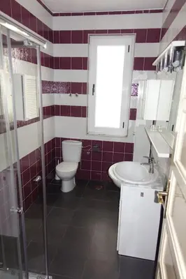 a bathroom with a toilet and a sink and a shower at Yellow Door 2 in Ponferrada