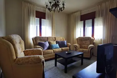 a living room with a couch and two chairs and a table at Foz Acogedora casa familiar in Barrosa