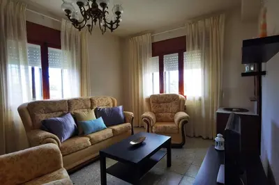 a living room with a couch and a table at Foz Acogedora casa familiar in Barrosa
