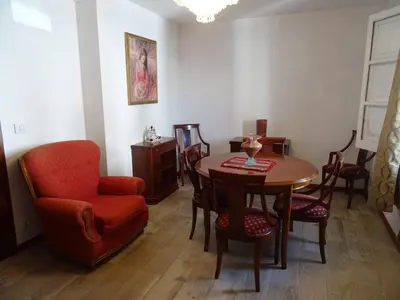 a living room with a table and chairs and a chair at Piso en centro urbano de Puentedeume con terraza in Puentedeume