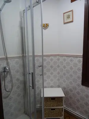 a shower with a glass door in a bathroom at Piso en centro urbano de Puentedeume con terraza in Puentedeume