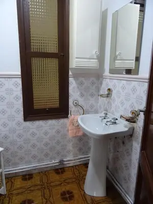 a bathroom with a white sink and a mirror at Piso en centro urbano de Puentedeume con terraza in Puentedeume