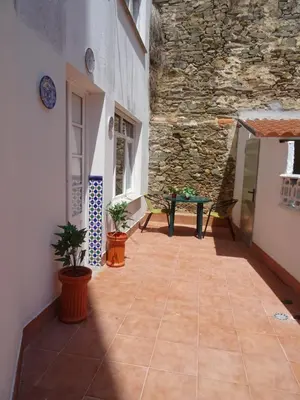 a room with a stone wall and a patio at Piso en centro urbano de Puentedeume con terraza in Puentedeume
