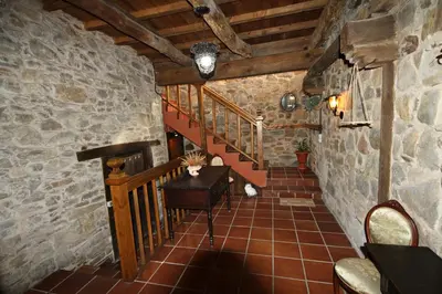 a hallway with a staircase in a stone building at CASA MAGUETO 2 noches mínimo in Toreno