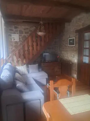 a living room with a couch and a table at CASA MAGUETO 2 noches mínimo in Toreno