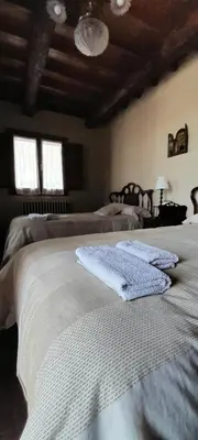 a bedroom with two beds and two windows at Casa de Abril 2 in San Cristóbal de Valdueza