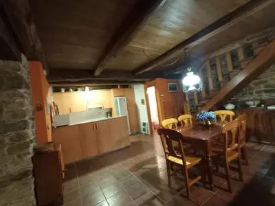 a kitchen and dining room with a table and chairs at Casa de Abril 2 in San Cristóbal de Valdueza