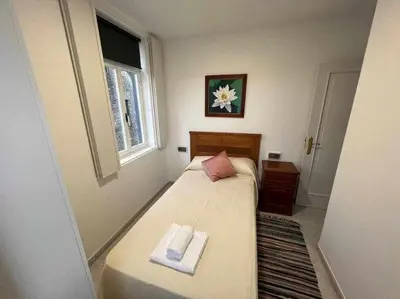 a bedroom with a bed with two towels on it at Apartamento A in Irijoa