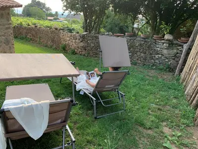 a table and two chairs and a table with a lamp at Casa Fogar do Ulla in Vedra