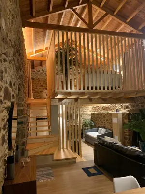 a wooden staircase in a living room with a couch at Casa Fogar do Ulla in Vedra