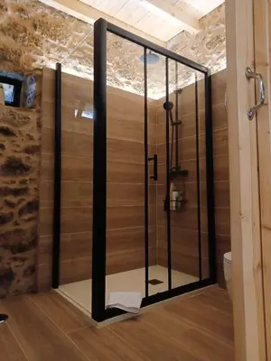 a shower with a glass door in a bathroom at Casa Fogar do Ulla in Vedra