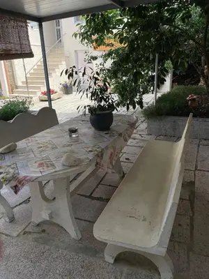 a picnic table and bench with a table and a tree at A Casa do Abuelo in Ourense