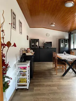 a kitchen and dining room with a table and chairs at A Casa do Abuelo in Ourense
