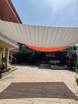 a large rainbow colored umbrella over a patio at A Casa do Abuelo in Ourense