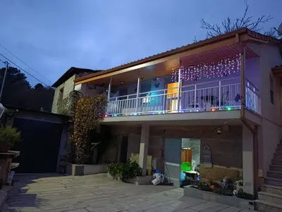 a house with a balcony with christmas lights on it at A Casa do Abuelo in Ourense