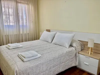 a bedroom with a bed with two towels on it at Apartamento Ribeira Sacra in Monforte de Lemos