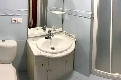 a bathroom with a sink and a toilet at Apartamento Ribeira Sacra in Monforte de Lemos