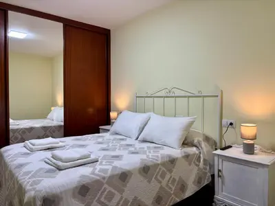 a bedroom with a bed with two towels on it at Apartamento Ribeira Sacra in Monforte de Lemos