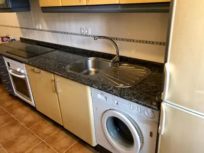 a kitchen with a sink and a washing machine at Apartamento Ribeira Sacra in Monforte de Lemos