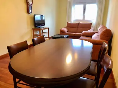 a living room with a table and a couch at Apartamento Ribeira Sacra in Monforte de Lemos