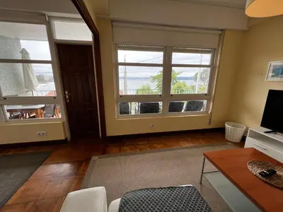 a living room with two windows and a television at Oktheway Perbes Vintage 2 in Perbes