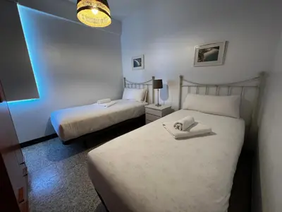a bedroom with two beds with a towel on the bed at Oktheway Perbes Vintage 2 in Perbes