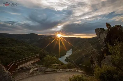a view of the sun setting over a river at Fogar Rivoira Sacrata in Castro Caldelas