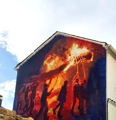 a painting of people on the side of a building at Fogar Rivoira Sacrata in Castro Caldelas