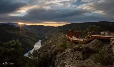 a bridge on the side of a mountain overlooking a river at Fogar Rivoira Sacrata in Castro Caldelas