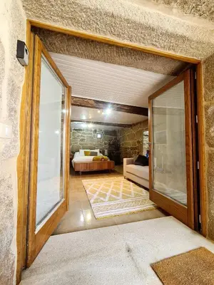 a kitchen with a refrigerator and a washing machine at A aira da xoaniña in Allariz