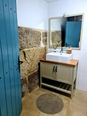 a bathroom with a toilet and a glass shower at A aira da xoaniña in Allariz