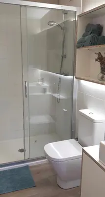 a white bathroom with a shower and a toilet at LOFT CON TERRAZA en el centro de Santiago de Compostela VUTCO 07320 in Santiago de Compostela