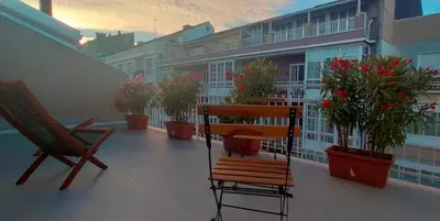 a balcony with a bench and potted plants on a building at LOFT CON TERRAZA en el centro de Santiago de Compostela VUTCO 07320 in Santiago de Compostela