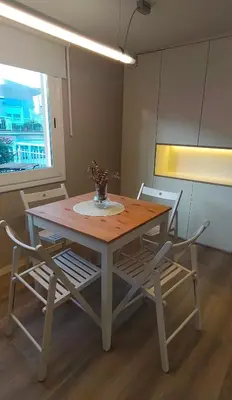 a dining room table with two chairs and a window at LOFT CON TERRAZA en el centro de Santiago de Compostela VUTCO 07320 in Santiago de Compostela