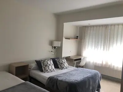 a hotel room with a bed and a window at Pensión Cantabrico in Navia