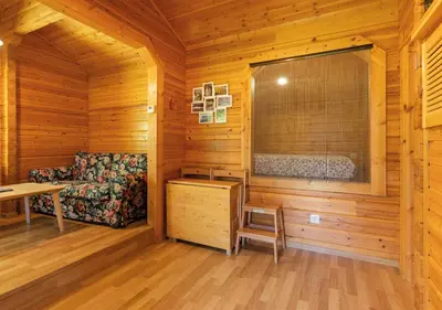 a log cabin living room with a couch and a table at Cabañas El Ruso in Galende