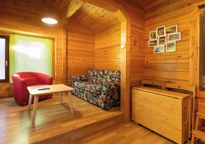 a room with a couch and a table and a chair at Cabañas El Ruso in Galende