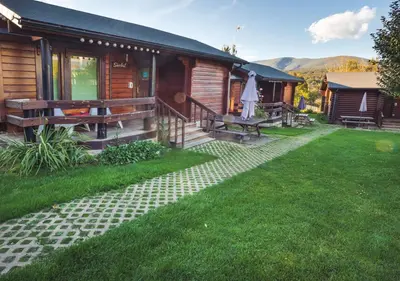 a log cabin with a porch and a patio at Cabañas El Ruso in Galende