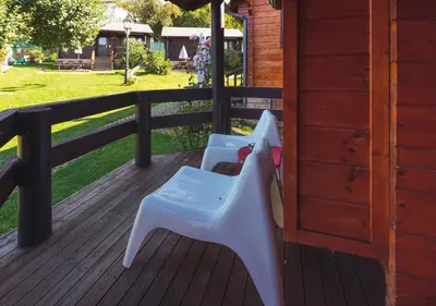 a white chair sitting on a wooden deck at Cabañas El Ruso in Galende